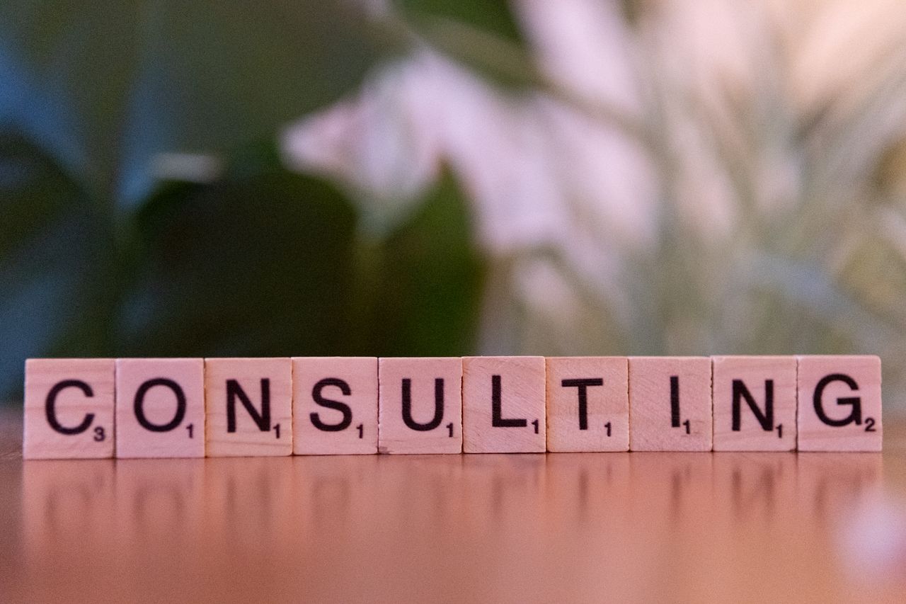 heros-img Wooden letter tiles spelling 'Consulting' with a blurred background. Ideal for business concepts.